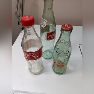 3 glass bottles- Coca cola classic , Coca Cola Atlanta and Coca Cola Refresco